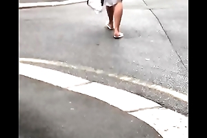 Crestfallen blonde wearing thong footslogger up the street