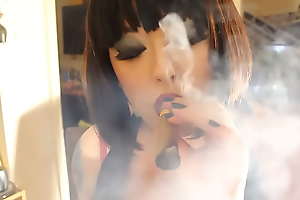 BBW Mistress Tina Snua Smokes A Cigar Showing Off Cleavage